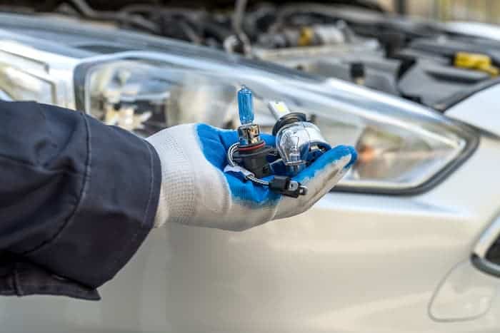What is done during headlight bulb replacement